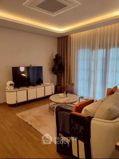 Elegant living room with modern decor, cozy seating, and ambient lighting for a luxurious lifestyle.