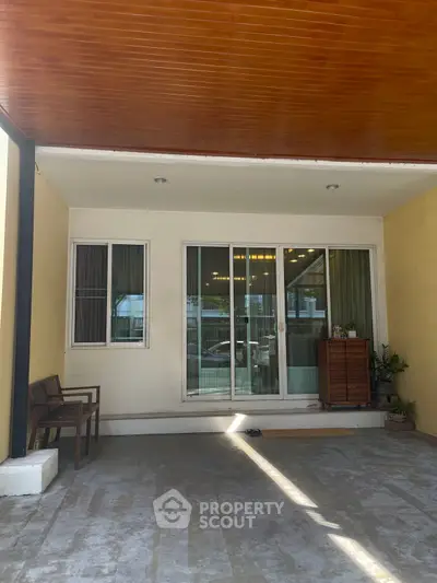Charming entrance with sliding glass doors and cozy seating area