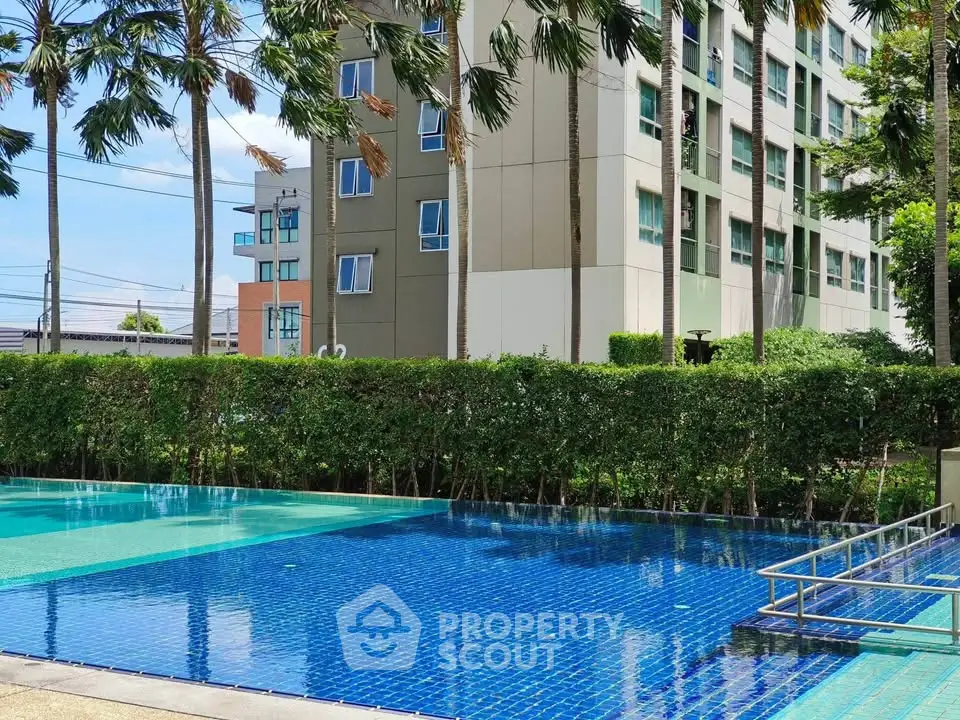 Modern apartment building with a refreshing outdoor pool and lush greenery, perfect for relaxation and leisure.