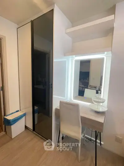 Modern bedroom with sleek wardrobe and illuminated vanity desk, perfect for stylish living.