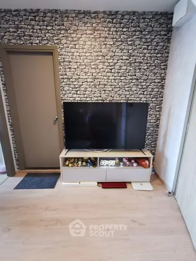 Modern living room with stylish stone accent wall and sleek TV setup