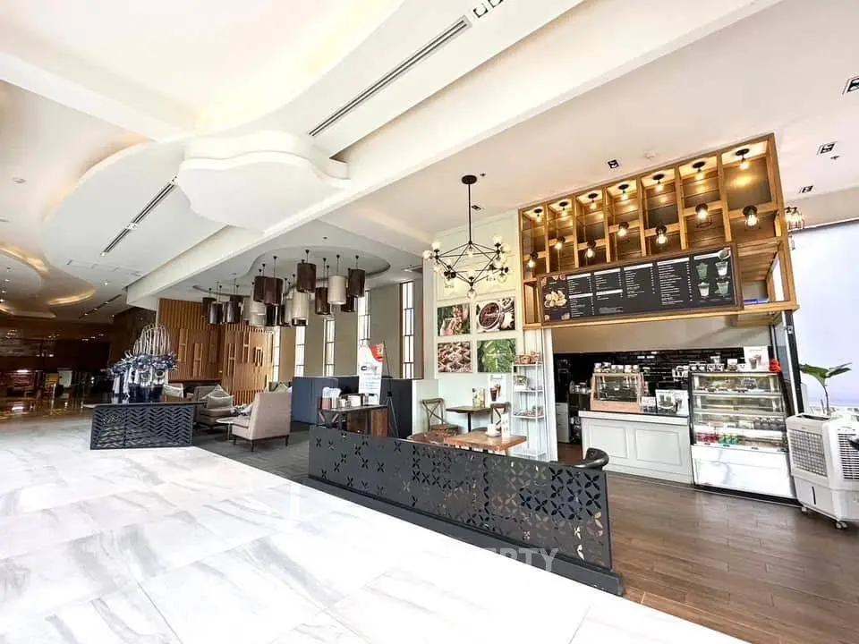 Luxurious modern lobby with chic café and elegant seating area, perfect for relaxation and socializing.