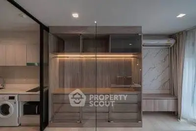Modern interior with built-in storage and washing machine in sleek apartment design.
