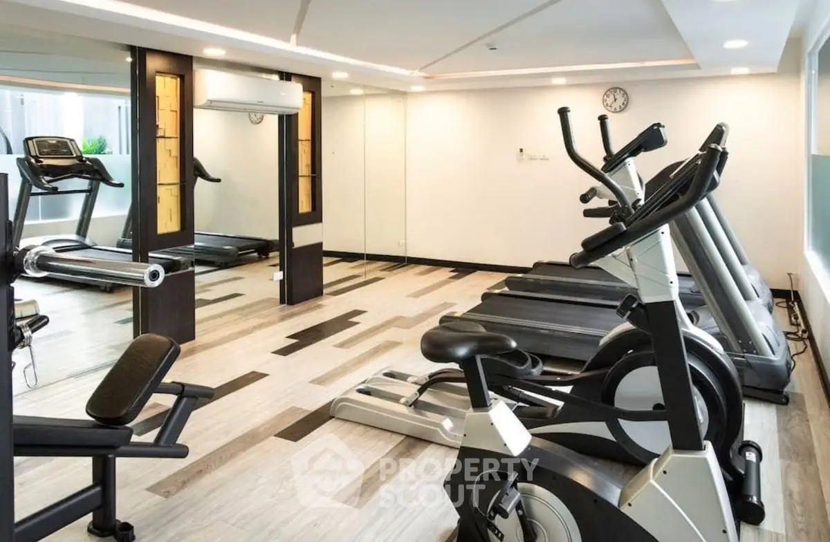 Modern gym with state-of-the-art fitness equipment in a luxury residential building.
