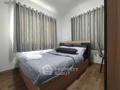 Cozy bedroom with modern decor and ample natural light