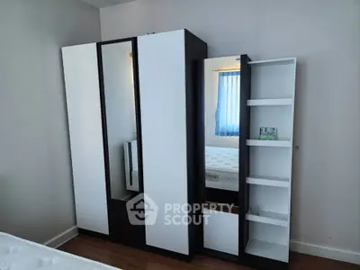 Modern bedroom with sleek wardrobe and cozy bed, perfect for stylish living.