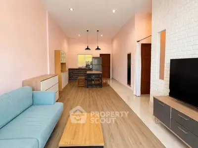 Spacious open-plan living room with modern furnishings and stylish kitchen area.