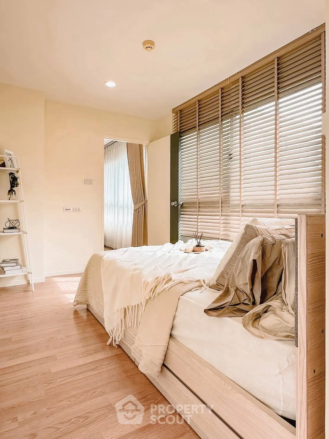 Cozy bedroom with wooden flooring and natural light