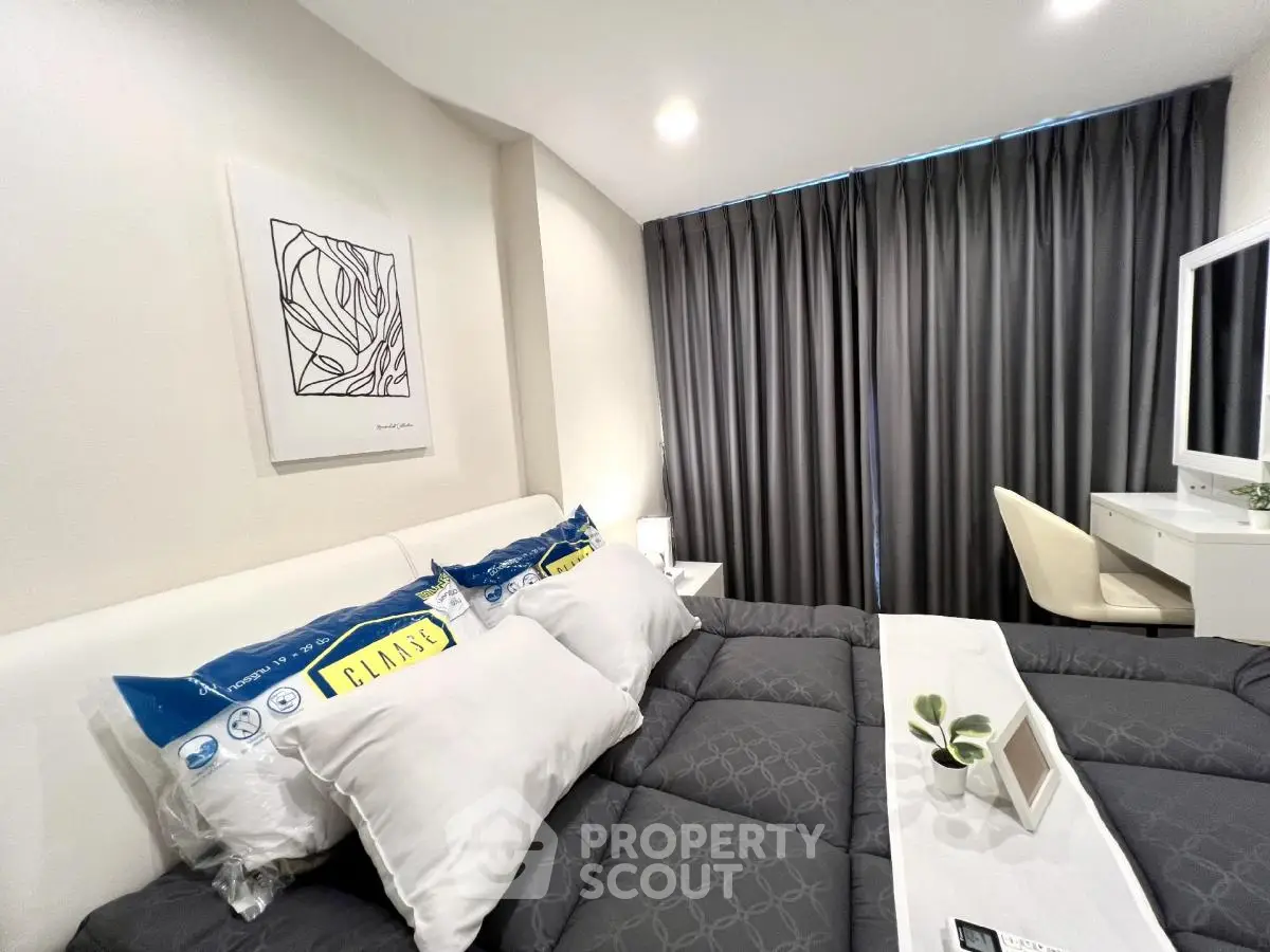 Modern bedroom with stylish decor and cozy bedding in a contemporary apartment.