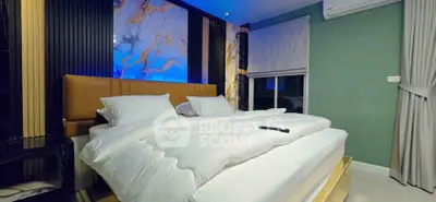 Luxurious bedroom with modern decor and ambient lighting, featuring a plush bed and stylish wall art.