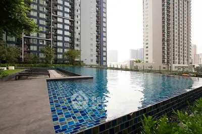 Luxurious high-rise apartment complex with stunning outdoor pool and city views.