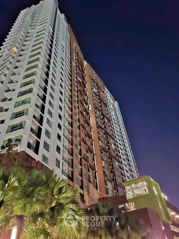 Stunning high-rise building with modern architecture against a night sky backdrop.