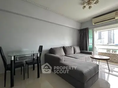 Modern living room with sleek furniture and city view balcony in urban apartment.