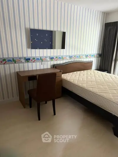 Cozy bedroom with stylish wallpaper and modern furniture, perfect for a comfortable living experience.