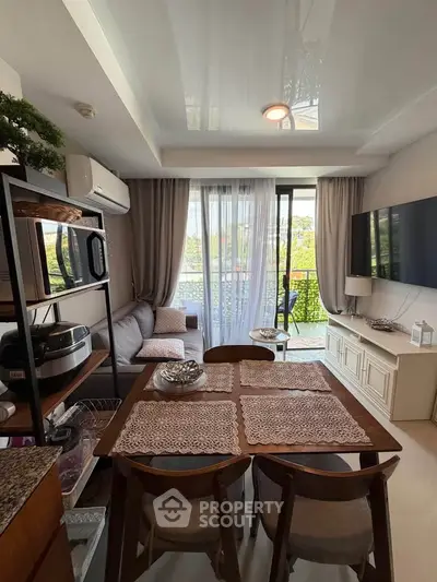 Chic living room with modern decor and balcony view, perfect for urban living.