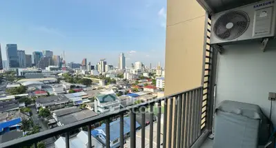 Stunning cityscape view from a high-rise balcony with air conditioning unit.