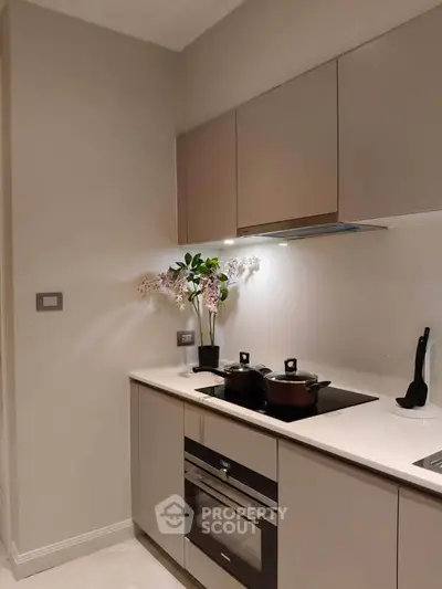 Modern kitchen with sleek cabinets and built-in oven