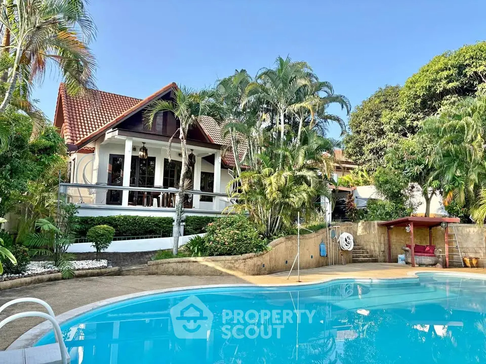 Stunning tropical villa with lush garden and inviting pool, perfect for luxurious living and entertaining.