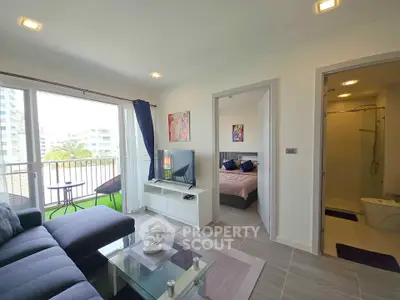 Modern living room with balcony access and stylish decor in a contemporary apartment.