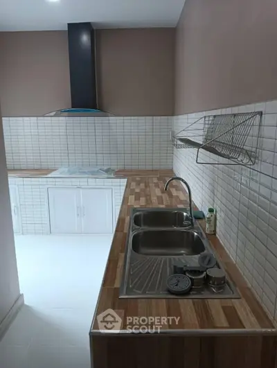 Modern kitchen with stylish wooden countertops and sleek stainless steel sink