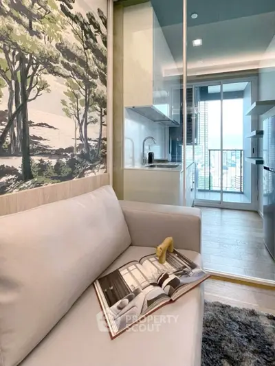 Modern compact living room with open kitchen and balcony view, featuring stylish decor and natural light.
