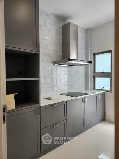 Modern kitchen with sleek cabinetry and electric stove