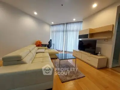 Spacious modern living room with sleek furniture and natural light.
