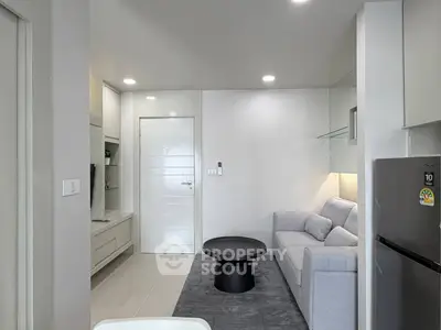 Modern living room with sleek design, featuring a cozy sofa and stylish decor in a contemporary apartment.