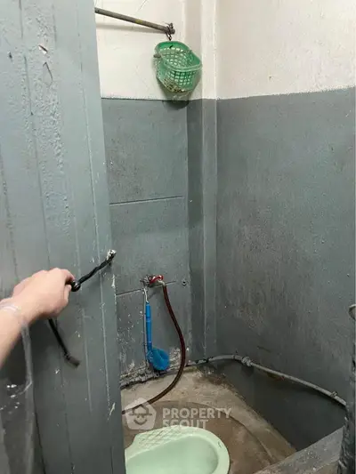 Compact bathroom with basic amenities and minimalist design