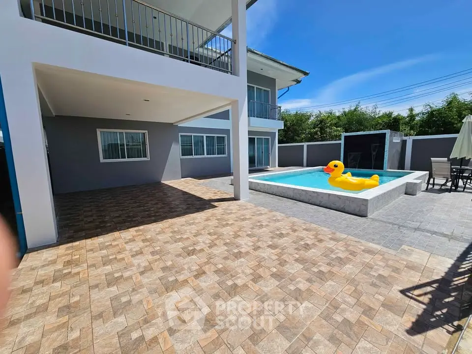 Spacious modern home with pool and patio, perfect for outdoor relaxation.