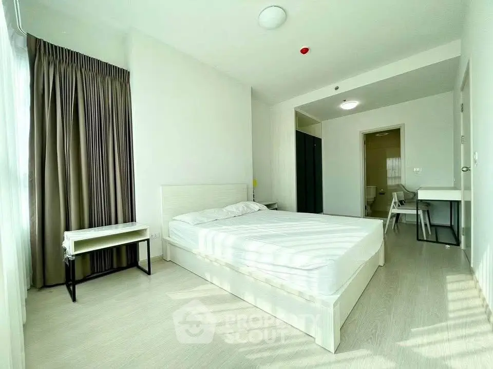 Bright and spacious bedroom with modern furnishings and natural light