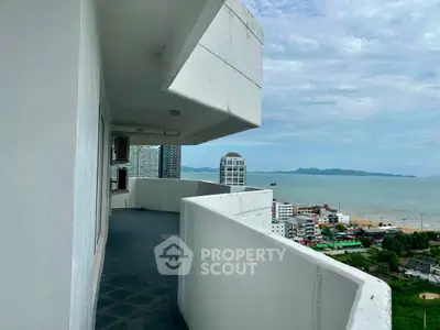 Stunning high-rise balcony with panoramic ocean views and cityscape, perfect for relaxation and enjoying sunsets.