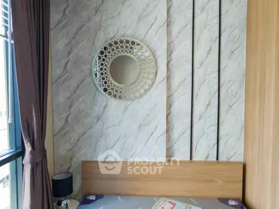 Stylish bedroom with modern decor and unique wall mirror design