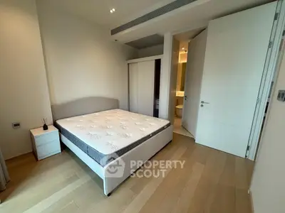 Spacious bedroom with modern design and ensuite bathroom in luxury apartment