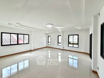 Spacious and bright living room with elegant ceiling design and large windows.
