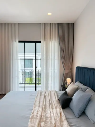 Elegant bedroom with modern decor and large window view