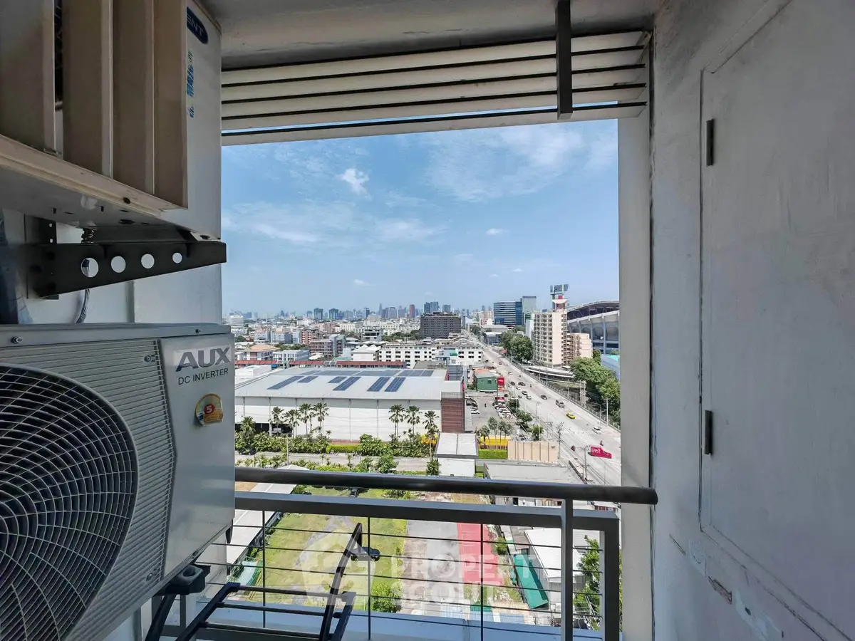 Stunning cityscape view from a high-rise balcony with modern AC unit, perfect for urban living.