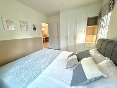 Cozy bedroom with modern decor and ample natural light