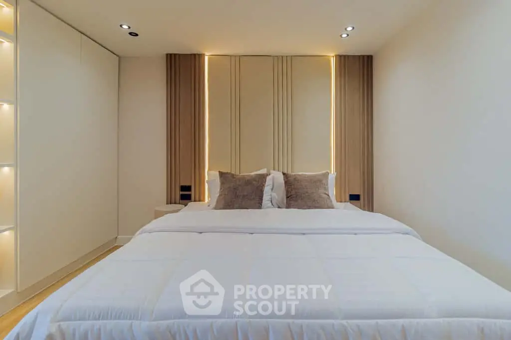 Luxurious modern bedroom with elegant lighting and plush bedding