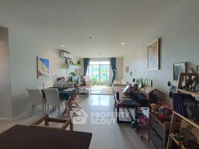 Spacious living room with modern decor and large windows offering natural light