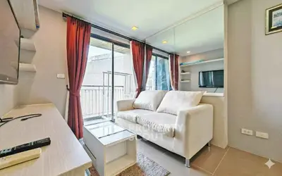Modern living room with balcony access and stylish decor in urban apartment