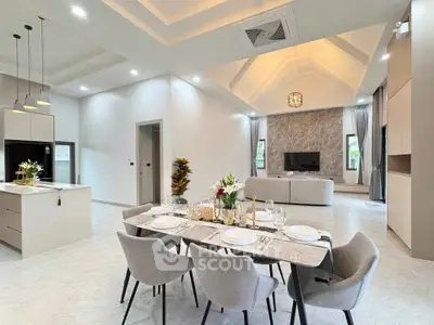 Luxurious open-plan living and dining area with modern kitchen and elegant decor.