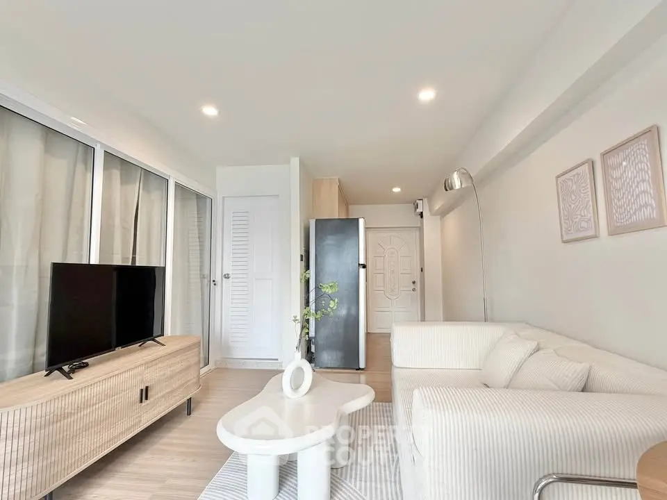 Modern living room with sleek furniture and natural light, perfect for relaxation and entertainment.