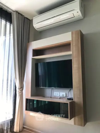 Modern living room with wall-mounted TV and air conditioning unit