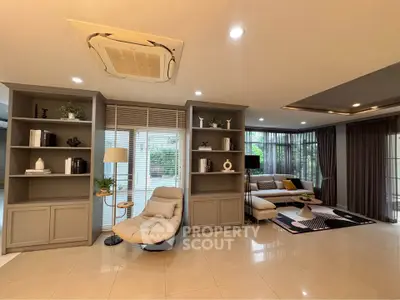 Spacious modern living room with elegant decor and large windows for natural light.