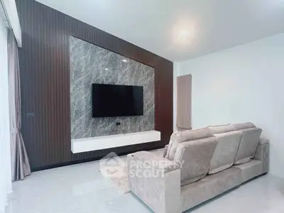 Modern living room with sleek TV wall and plush sofa