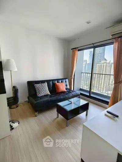 Modern living room with city view, sleek furniture, and natural light.