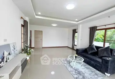 Spacious modern living room with sleek furniture and large windows.