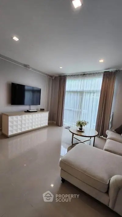 Modern living room with sleek TV setup and elegant furniture