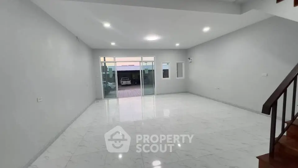Spacious modern living room with marble flooring and large windows